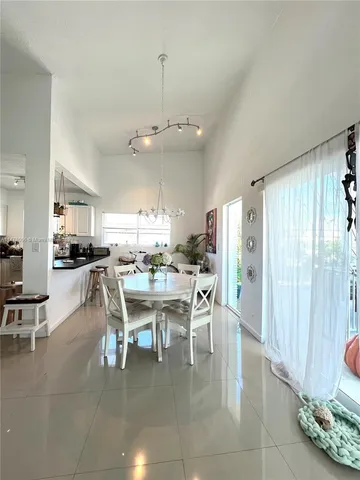 a balcony of a house with wooden floor and outdoor seating