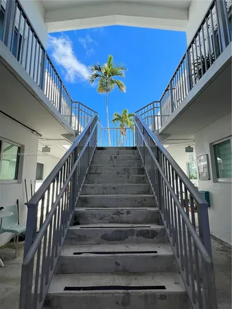 a view of a ocean with boats and trees in the background