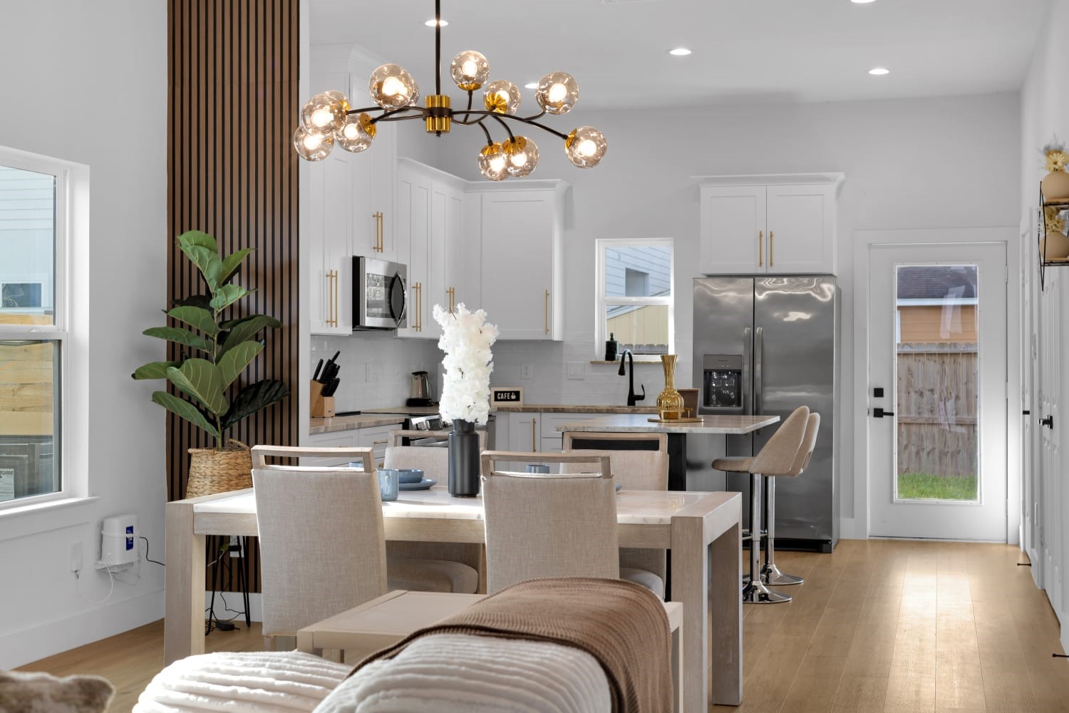 6726 Dumble Street, Unit B Houston, TX 77021 - Photo 27 of 42 a living room with furniture a chandelier and a dining room