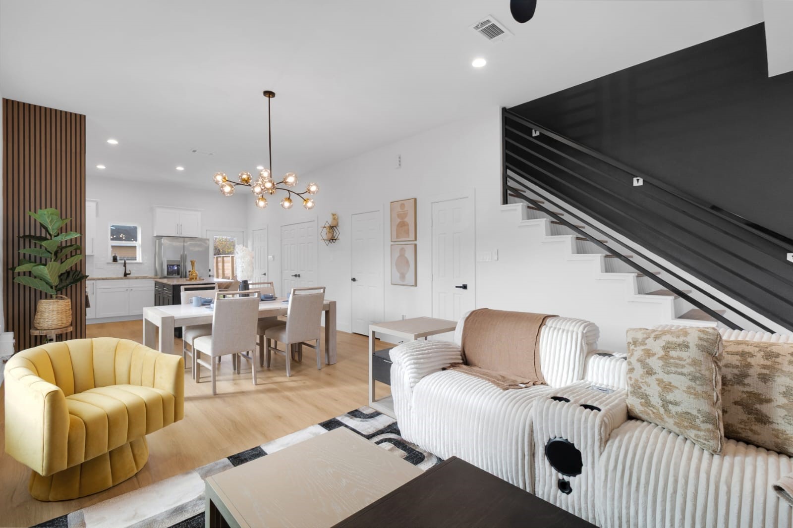 6726 Dumble Street, Unit B Houston, TX 77021 - Photo 32 of 42 a living room with furniture a chandelier and a dining table