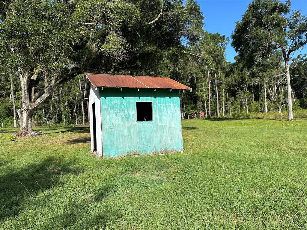 5542 Southwest 57th Avenue Gainesville, FL 32608 - Photo 12 of 15 a backyard of a house with table and chairs
