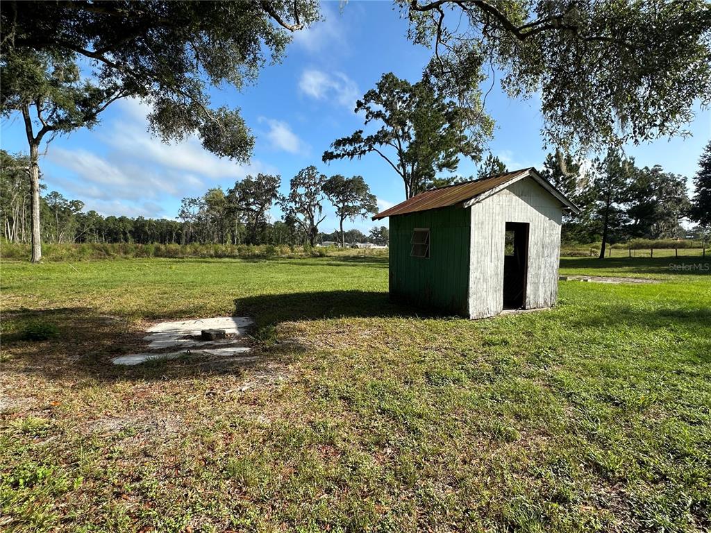 5542 Southwest 57th Avenue Gainesville, FL 32608 - Photo 15 of 15 a backyard of a house with a garden and outdoor seating