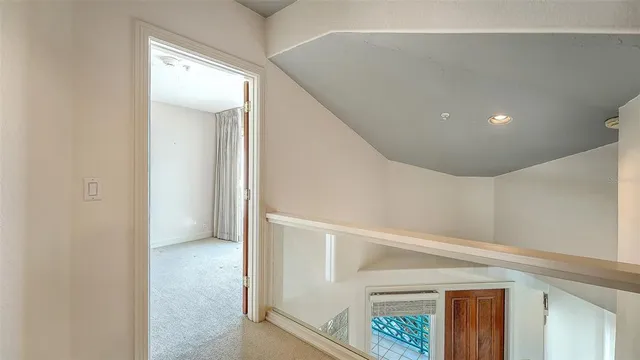 a bedroom with a large bed and a large mirror