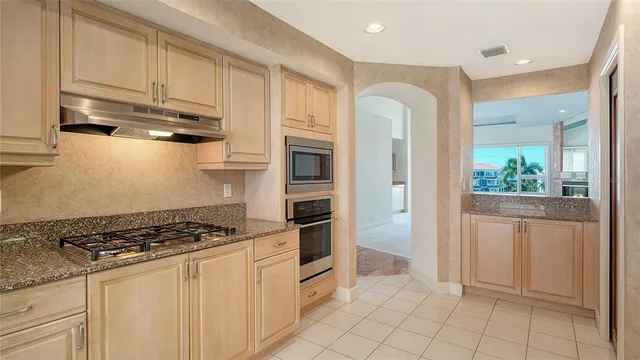 a kitchen with granite countertop a sink and cabinets