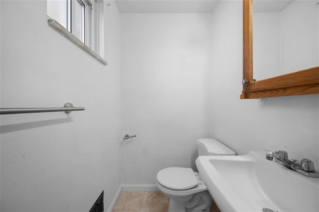 3620 New Texas Road Pittsburgh, PA 15239 - Photo 21 of 36 a white toilet sitting next to a bathroom sink