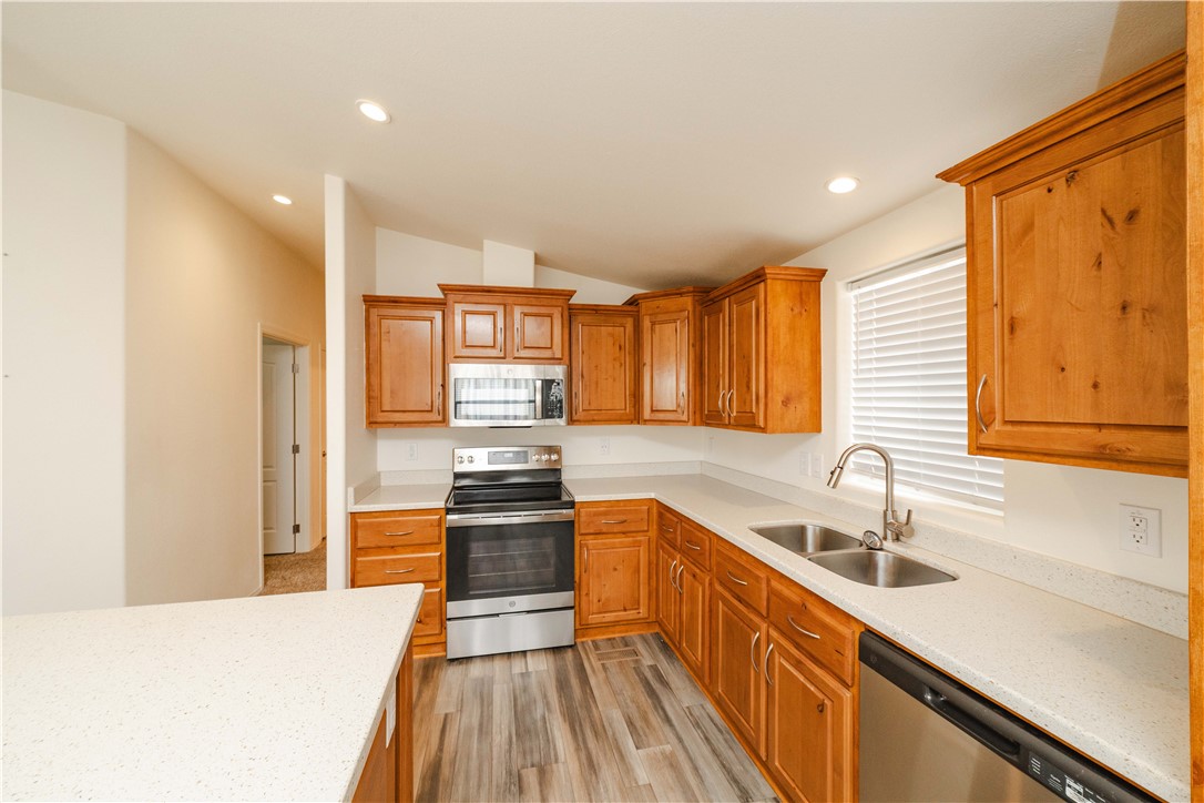 2001 Gold Road Kingman, AZ 86401 - Photo 12 of 57 a kitchen with stainless steel appliances a sink stove and cabinets