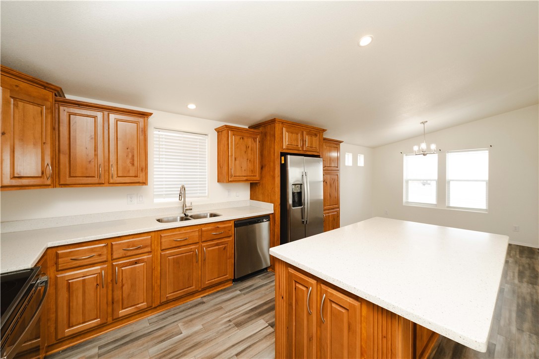 2001 Gold Road Kingman, AZ 86401 - Photo 14 of 57 a kitchen with stainless steel appliances granite countertop a sink dishwasher and a refrigerator with wooden cabinets