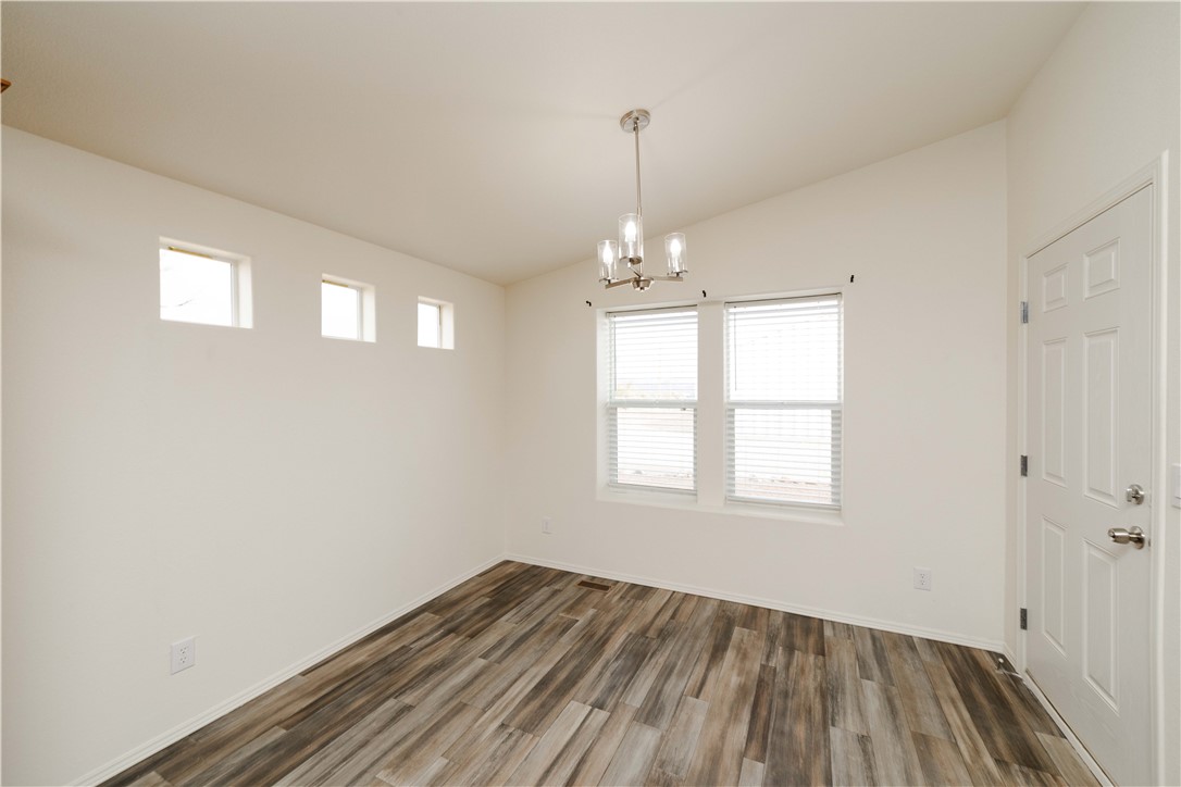 2001 Gold Road Kingman, AZ 86401 - Photo 6 of 57 a view of an empty room with wooden floor and a window