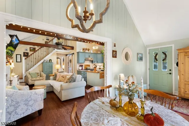 a living room with furniture and a chandelier