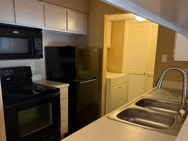 a kitchen with a sink and a refrigerator