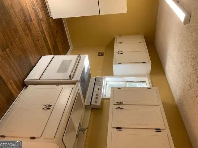 a view of a room with wooden floor and windows