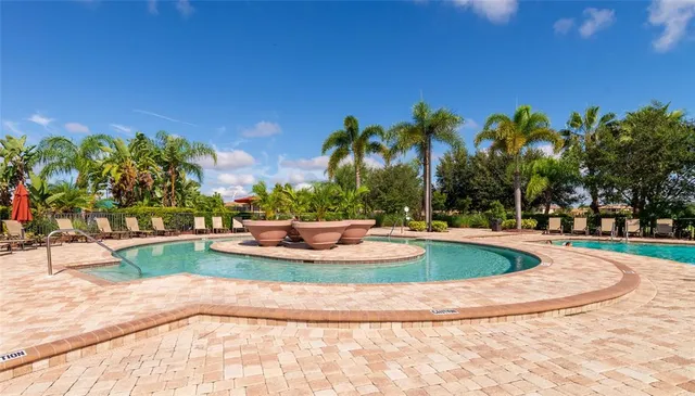a bedroom with a bed and paintings on the wall