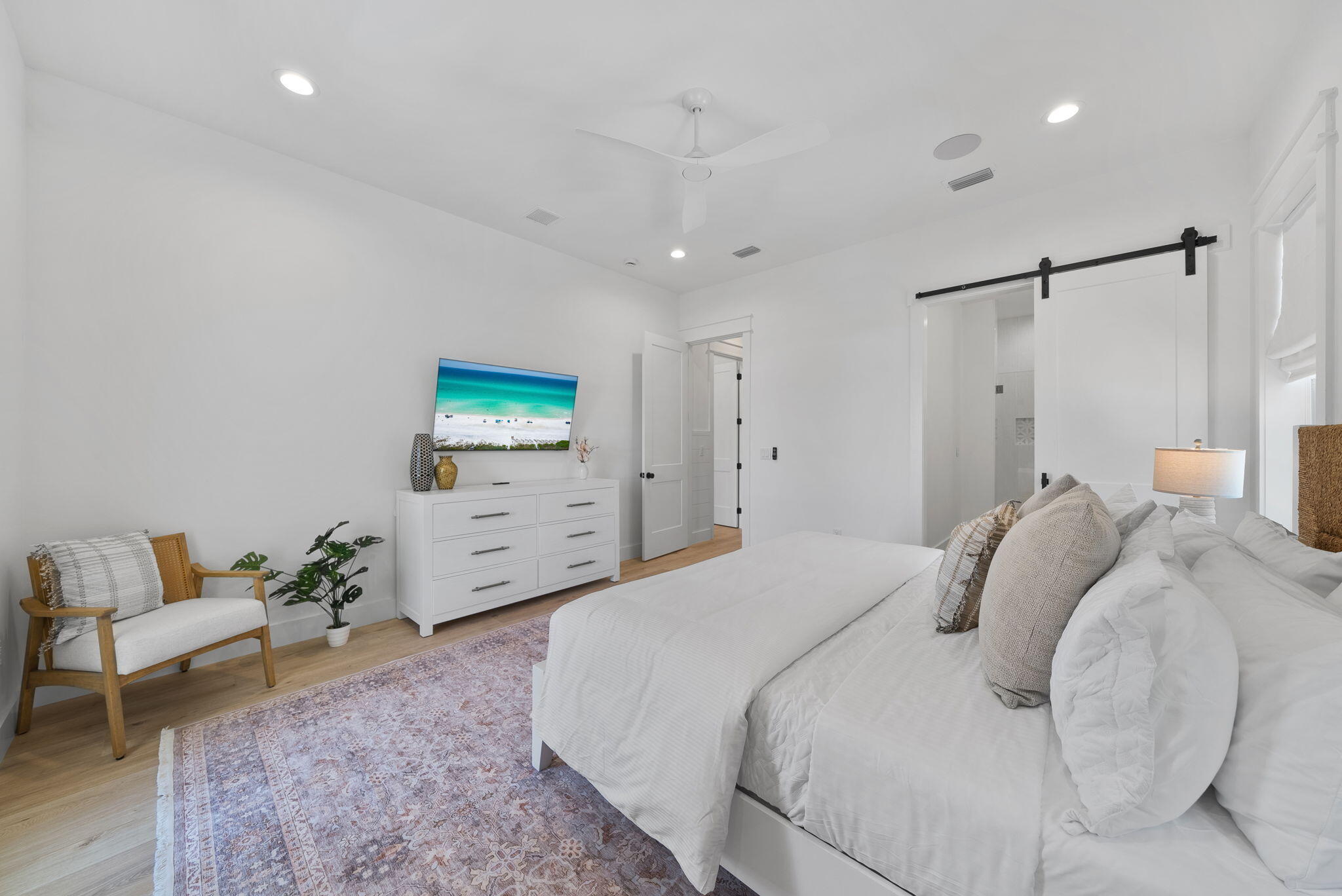 89 Sand Dollar Court Santa Rosa Beach, FL 32459 - Photo 47 of 89 a bedroom with a bed a couch and a flat screen tv