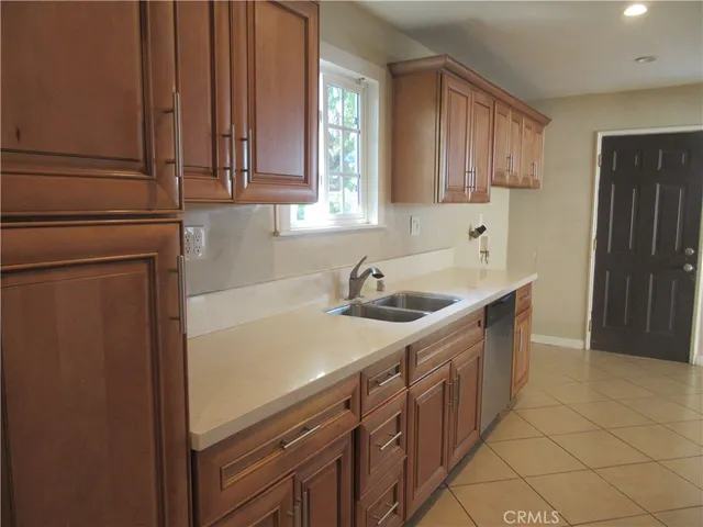 a kitchen with stainless steel appliances a sink dishwasher stove and refrigerator