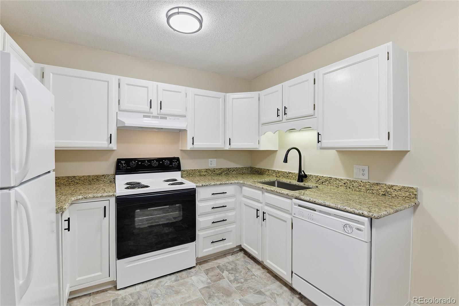 3022 South Wheeling Way, Unit 309 Aurora, CO 80014 - Photo 10 of 26 a kitchen with cabinets appliances and a sink