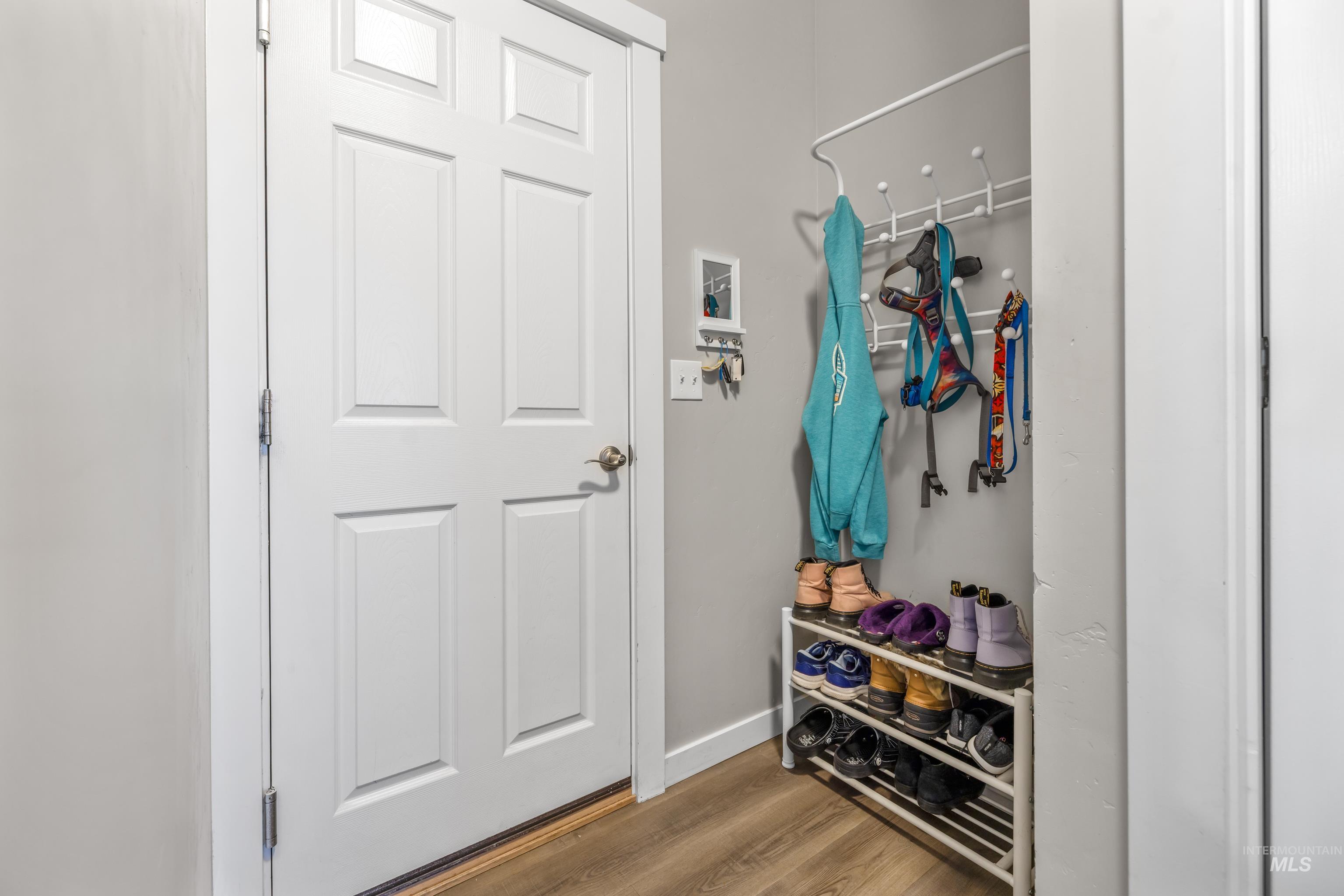 6988 West Spur Street Boise, ID 83709 - Photo 16 of 37 Mudroom featuring light wood-style floors and baseboards