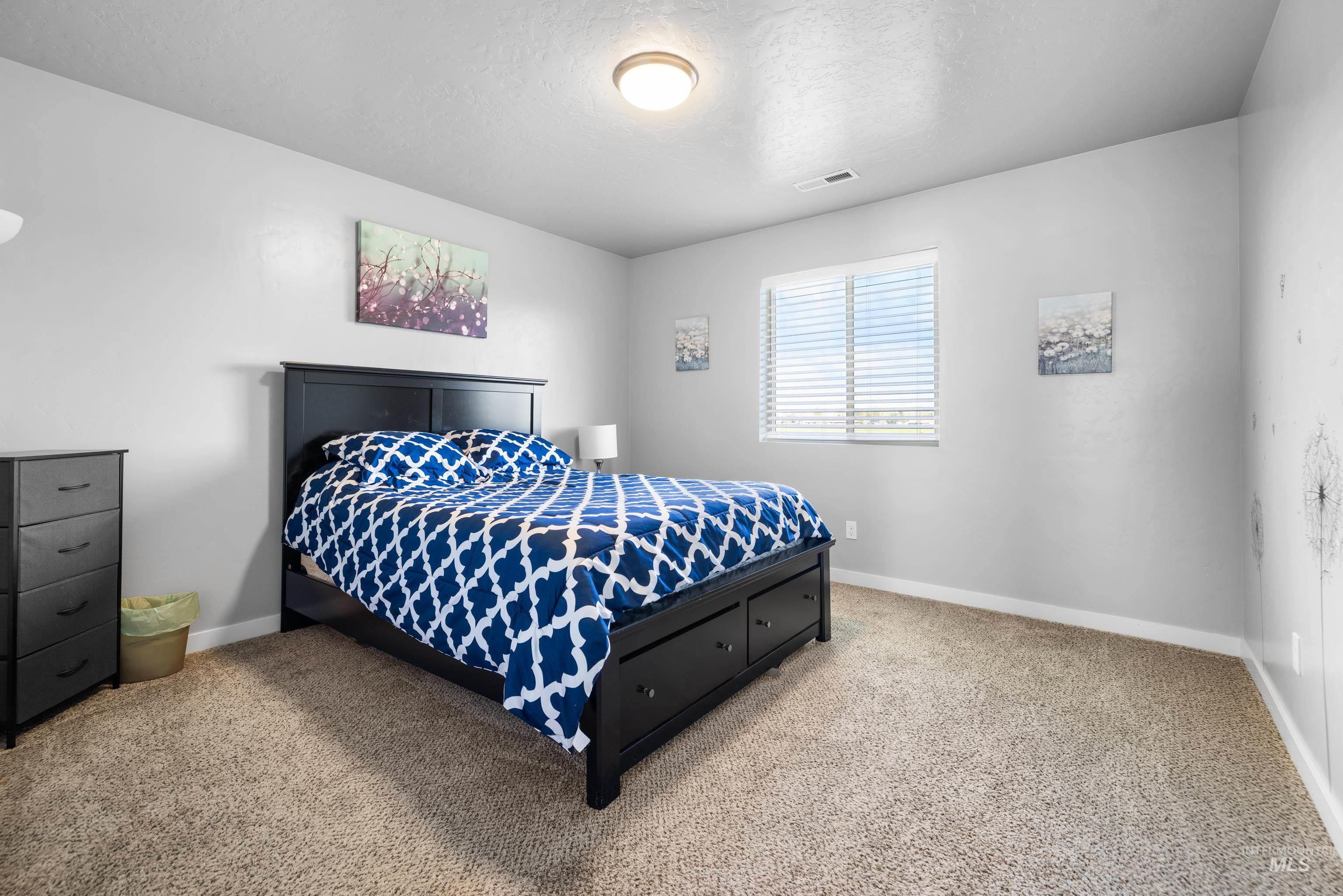 6988 West Spur Street Boise, ID 83709 - Photo 24 of 37 Bedroom with carpet floors and a textured ceiling