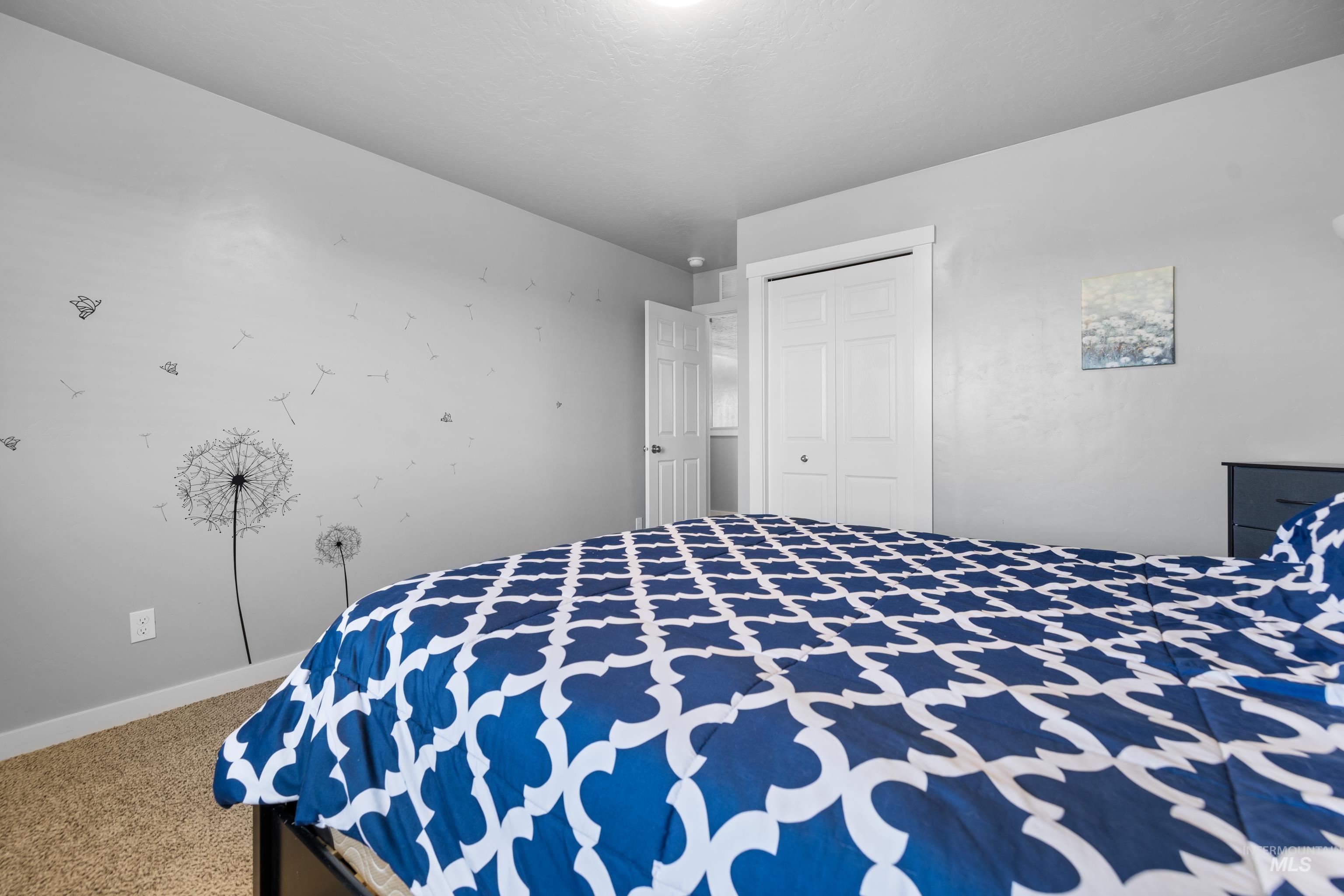 6988 West Spur Street Boise, ID 83709 - Photo 25 of 37 Bedroom featuring light carpet and a closet