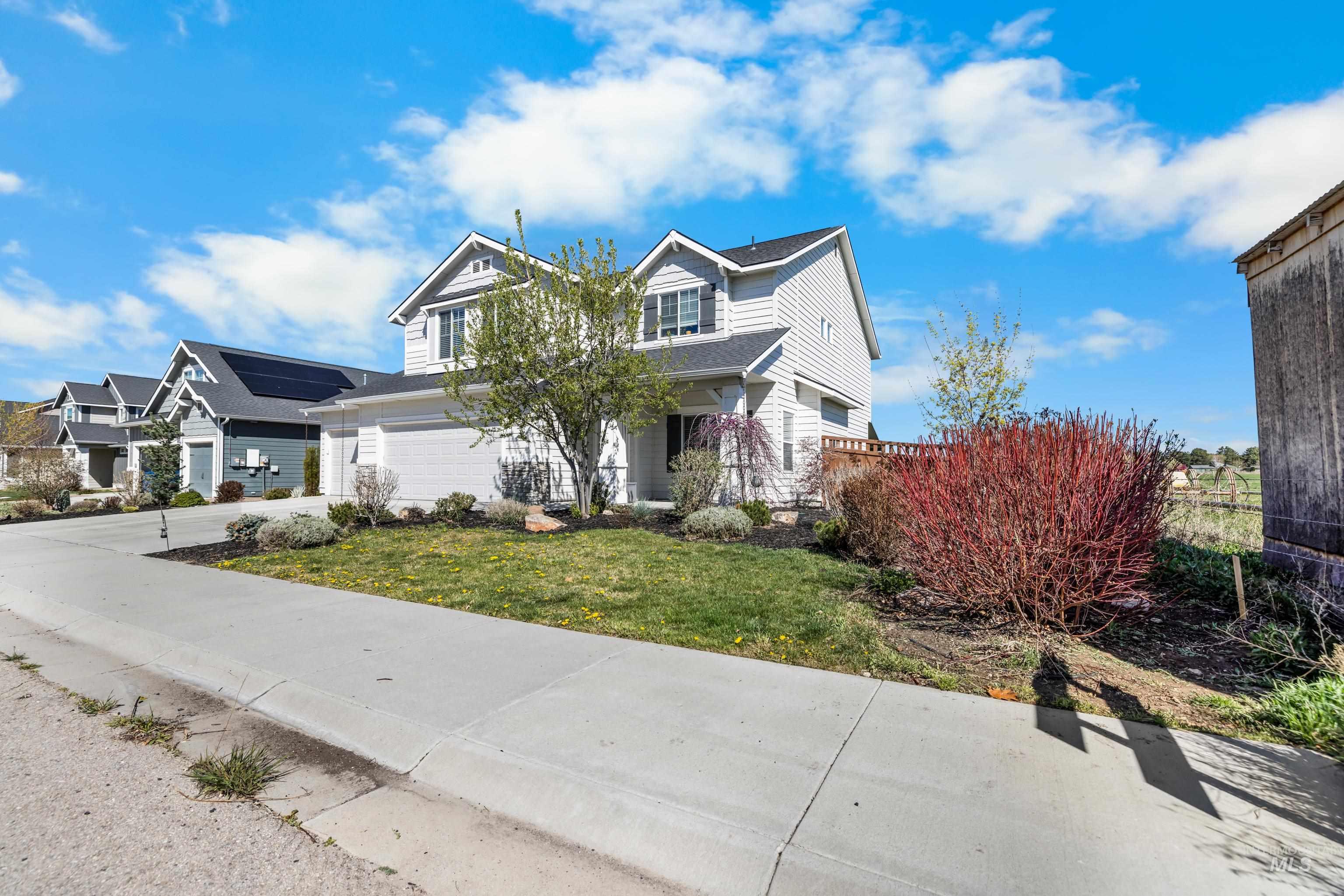 6988 West Spur Street Boise, ID 83709 - Photo 3 of 37 View of front of house with driveway and a garage