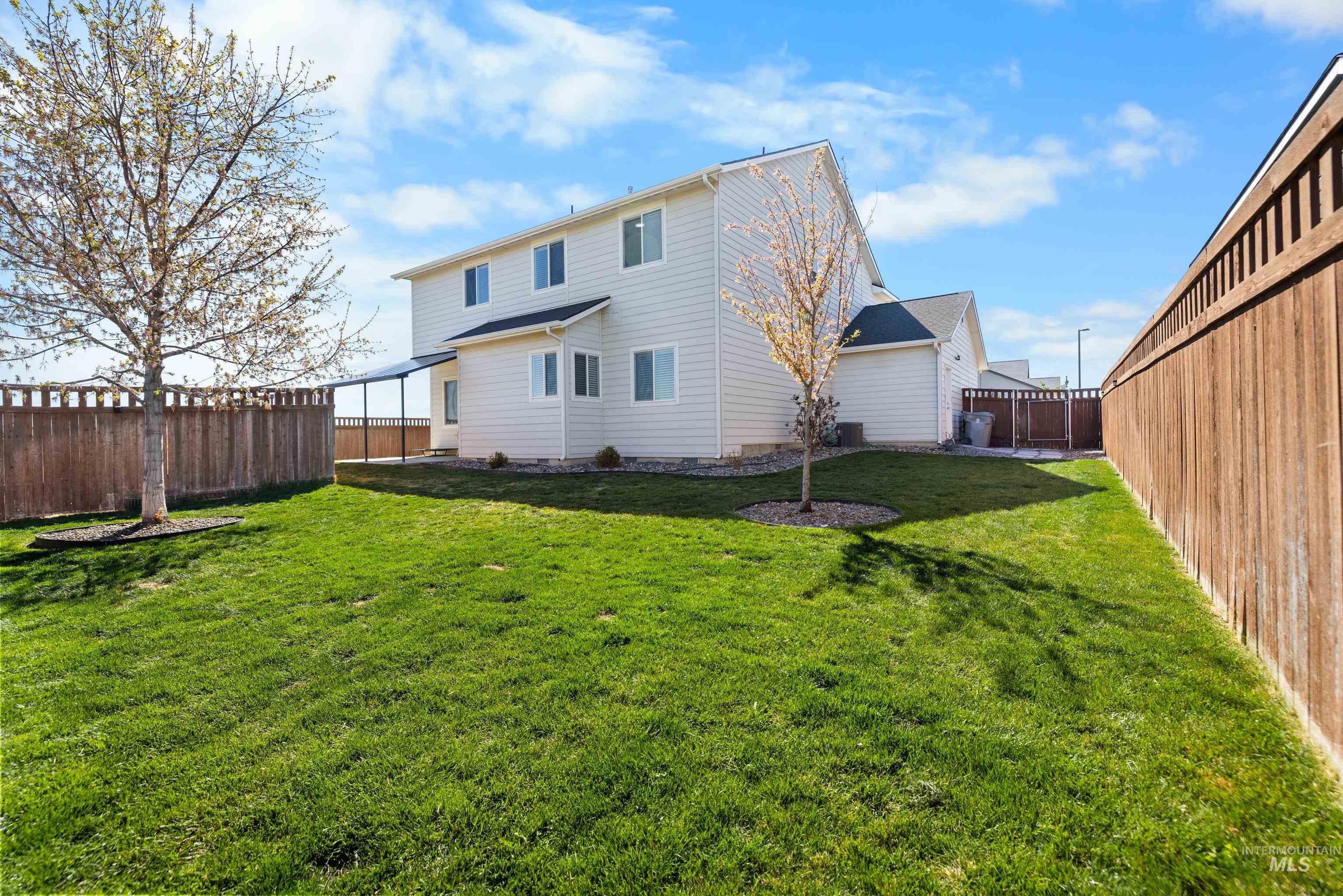 6988 West Spur Street Boise, ID 83709 - Photo 5 of 37 Rear view of property featuring a fenced backyard