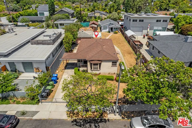 an aerial view of a house with a yard and potted plants