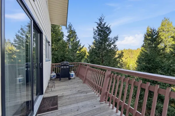 a bedroom with a bed a mirror and a window