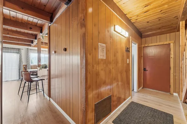 a view of a room with wooden floor