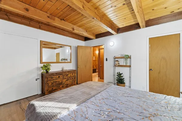 a bedroom with a large bed and a window