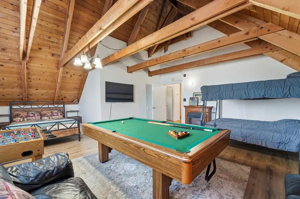 a view of a lush green forest with mountains in the background