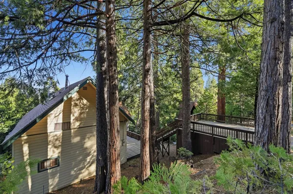 a view of balcony with wooden floor and fence and a bench