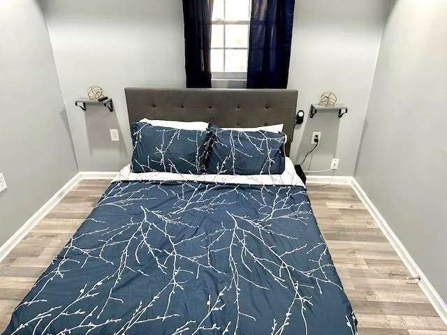 a bed sitting in a bedroom next to a window