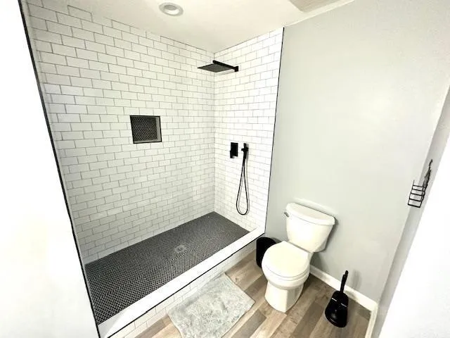a bathroom with a toilet and a shower
