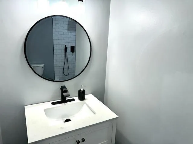 a bedroom with a bed and a ceiling fan