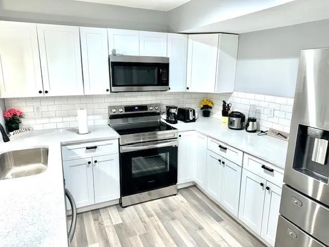 a kitchen with a sink and chandelier