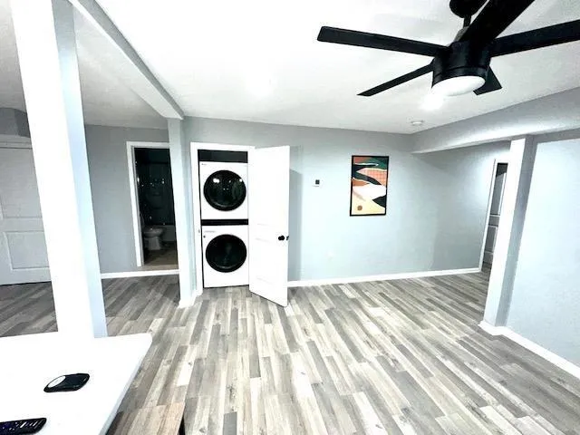 a room with stainless steel appliances furniture a flat screen tv and kitchen view