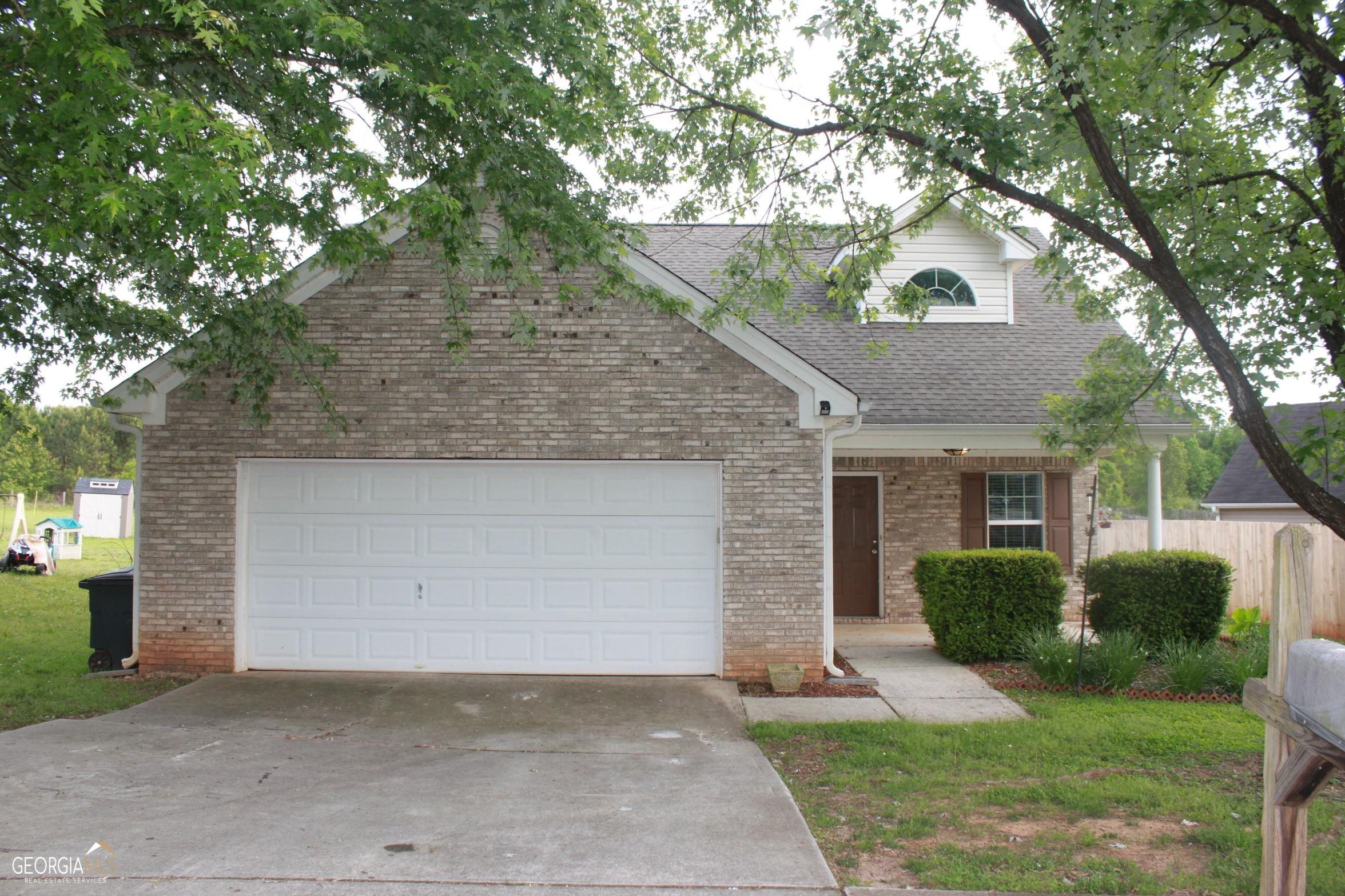 112 Tyler Way Jackson, GA 30233 - Photo 1 of 1 front view of a house with a yard and an trees