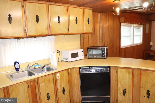 a kitchen with stainless steel appliances a stove a sink and a refrigerator