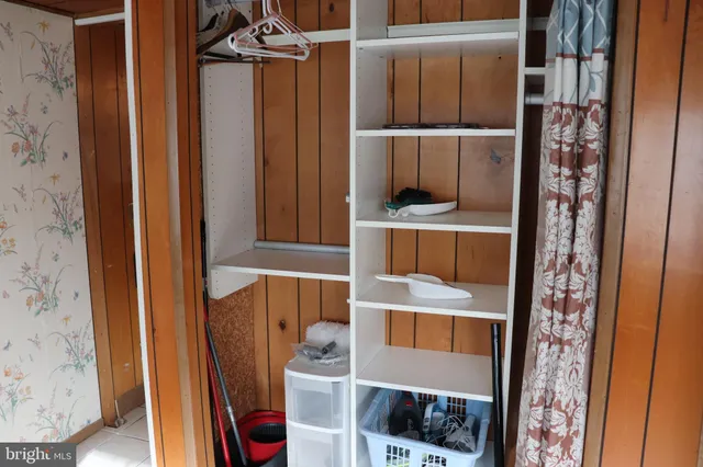 a bedroom with a bed dresser and a window