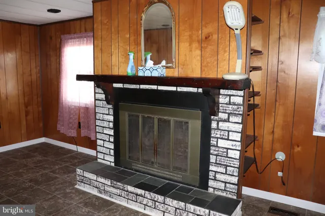a view of an empty room with a fireplace