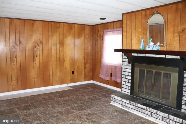 a view of a room that has a bed and a table in it