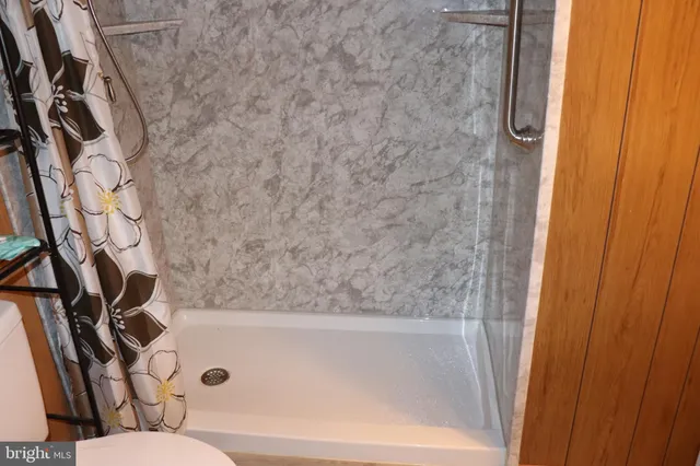 a view of a house with pool porch and wooden chairs