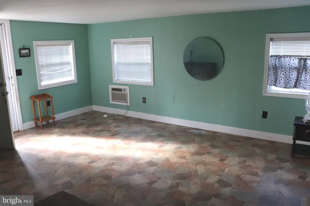 an empty room with windows and closet