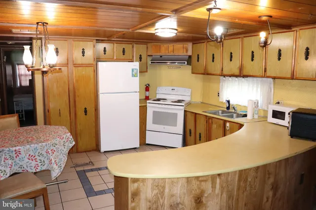 a kitchen with stainless steel appliances granite countertop a refrigerator a sink and a stove
