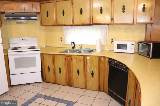 a kitchen with stainless steel appliances a stove a microwave and a refrigerator