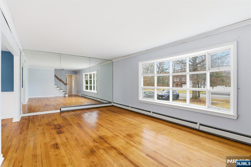 229 Edwards Road Parsippany, NJ 07054 - Photo 11 of 34 a view of an empty room with a fireplace and large windows
