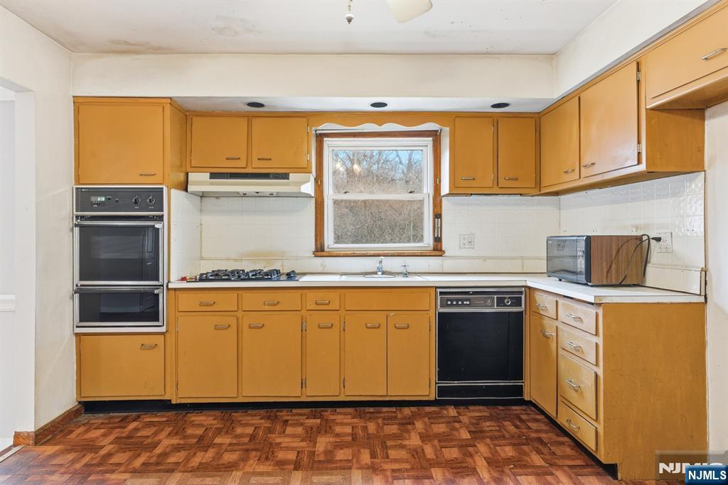 229 Edwards Road Parsippany, NJ 07054 - Photo 17 of 34 a kitchen with stainless steel appliances granite countertop a sink and cabinets