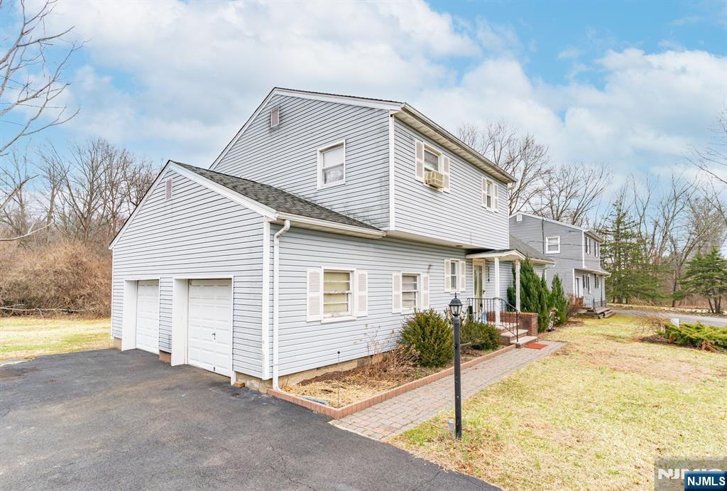 229 Edwards Road Parsippany, NJ 07054 - Photo 4 of 34 a front view of a house with a yard