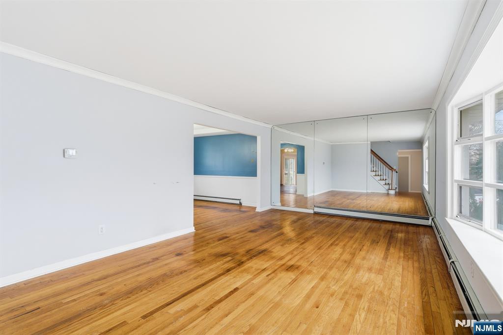 229 Edwards Road Parsippany, NJ 07054 - Photo 10 of 34 a view of a bedroom with wooden floor and a bed