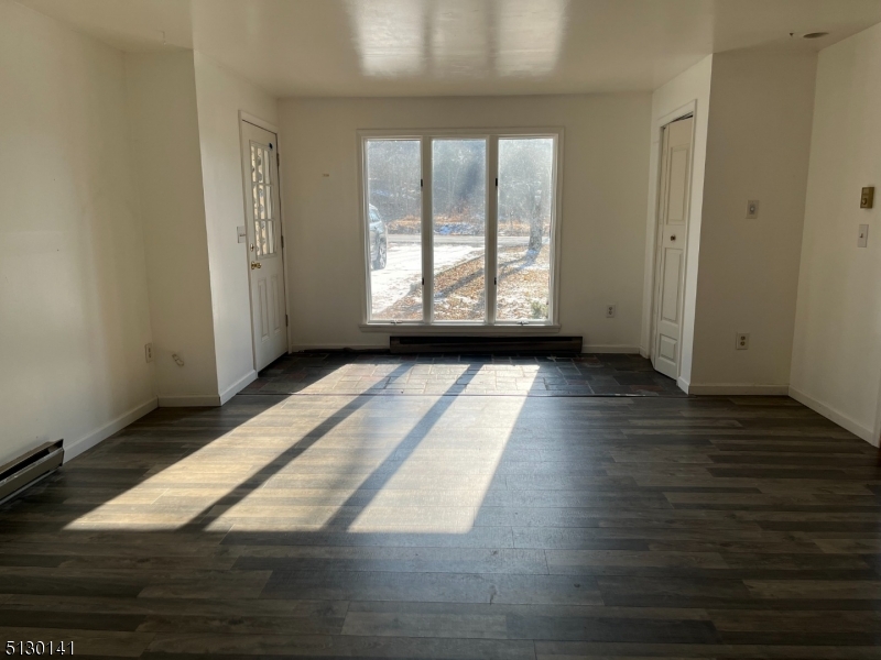 67 Rt 645 Layton, NJ 07851 - Photo 6 of 16 an empty room with wooden floor and windows