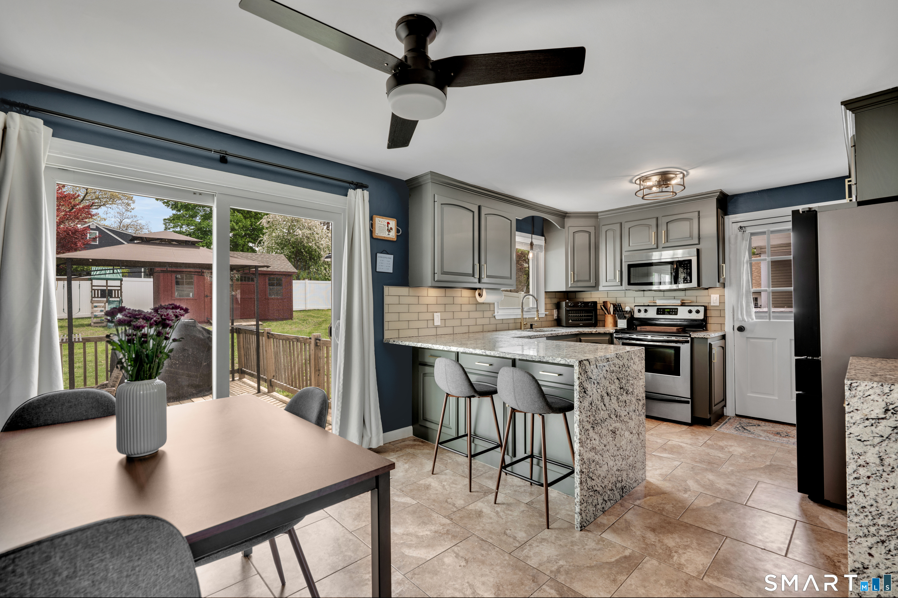 14 Baldwin Street Meriden, CT 06451 - Photo 11 of 35 a kitchen with refrigerator cabinets dining table and chairs